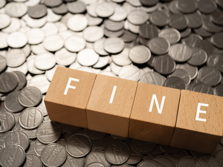 Wooden blocks with “FINE” text of concept and coins.